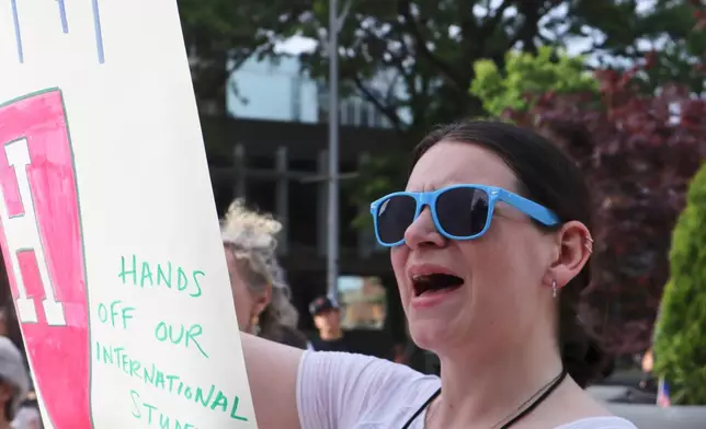 A protester cheers while listening to Harvard University students speak at a protest against President Donald Trump's recent sanctions against Harvard in front of Science Center Plaza on Tuesday, May 27, 2025, in Cambridge, Mass. (AP Photo/Leah Willingham)