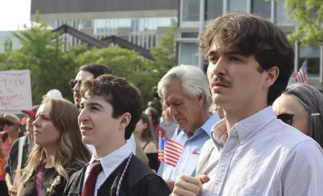 Protesters listen to Harvard University students speak at a protest against President Donald Trump's recent sanctions against Harvard in front of Science Center Plaza on Tuesday, May 27, 2025, in Cambridge, Mass. (AP Photo/Leah Willingham)