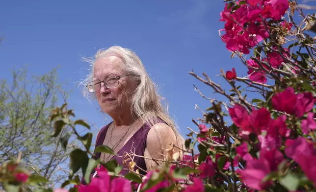 Linda Hilton, a 76-year-old retired office worker, stands in front of her home Tuesday, May 13, 2025, in Apache Junction, Ariz. (AP Photo/Ross D. Franklin)