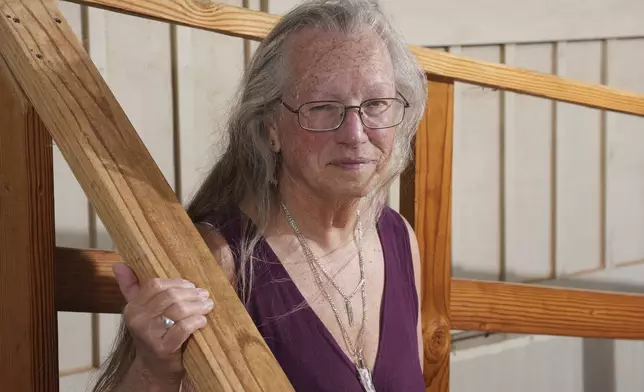 Linda Hilton, a 76-year-old retired office worker, stands in front of her home Tuesday, May 13, 2025, in Apache Junction, Ariz. (AP Photo/Ross D. Franklin)
