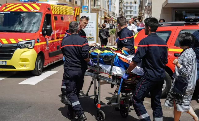 A palm tree fall on someone, and injured this person, on the Boulevard of La Croisette during the 78th international film festival, Cannes, southern France, Saturday, May 17, 2025. (Photo by Lewis Joly/Invision/AP)