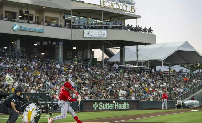 Los Angeles Angels' Logan O'Hoppe hits a home run during the fourth inning of a baseball game against the Athletics in West Sacramento, Calif., Wednesday, May 21, 2025. (AP Photo/Nic Coury)