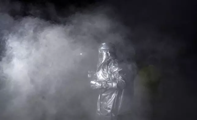 A firefighter participates in a drill to help train civilians and security personnel to respond in case of attack in Prayagraj, India, Wednesday, May 7, 2025 amid rising fears of wider conflict following India's strikes in Pakistan. (AP Photo/Rajesh Kumar Singh)