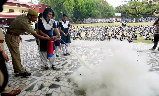 Indian civil defense volunteers and police participate in a mock security drill at a school in Prayagraj, India, Wednesday, May 7, 2025 amid rising fears of wider conflict following India’s strikes in Pakistan. (AP Photo/Rajesh Kumar Singh)