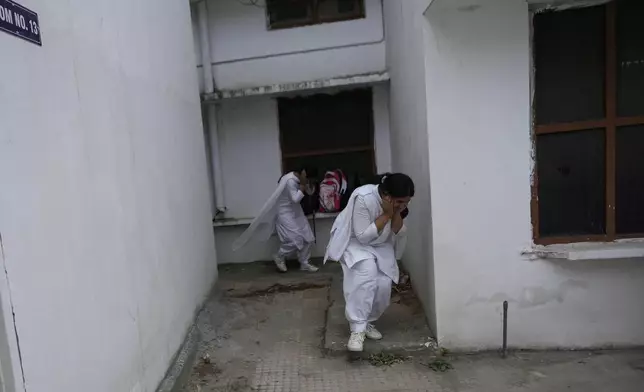 School students take shelter during mock drills amid India Pakistan tension, in Jammu, India, Tuesday, May 6, 2025. (AP Photo/Channi Anand)