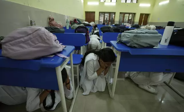 School students take shelter during mock drills amid India Pakistan tension, in Jammu, India, Tuesday, May 6, 2025. (AP Photo/Channi Anand)