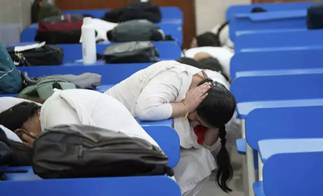 School students take shelter during mock drills amid India Pakistan tension, in Jammu, India, Tuesday, May 6, 2025. (AP Photo/Channi Anand)