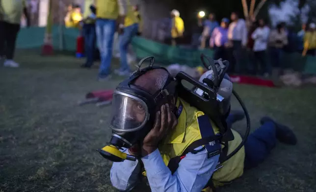 Officials take part in a drill to train civilians in case of attack in Prayagraj, India, Wednesday, May 7, 2025 amid rising fears of wider conflict following India's strikes in Pakistan. (AP Photo/Rajesh Kumar Singh)