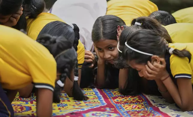 School students participate in a mock drill trained by civil defence members to respond in case of attack in Guwahati, India, Saturday, May 10, 2025 amid rising fears of wider conflict following India's strikes in Pakistan. (AP Photo/Anupam Nath)