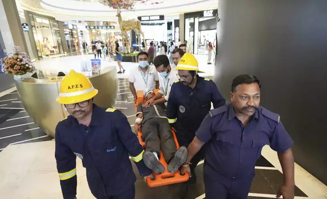 Fire brigade workers and paramedics participate in a security mock drill at a mall in Ahmedabad, India, Wednesday, May 7, 2025, amid rising fears of wider conflict following India's strikes in Pakistan. (AP Photo/Ajit Solanki)