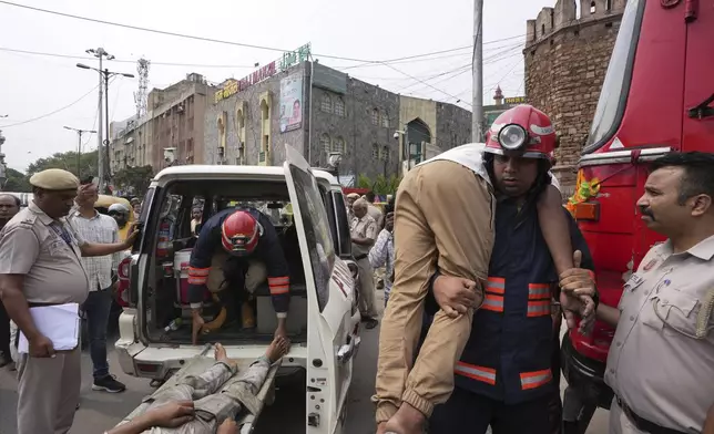 Firefighters carry out a mock drill to train civilians and security personnel to respond in case of an attack, in the old quarters of New Delhi, India, Saturday, May 10, 2025. (AP Photo/Karma Bhutia)