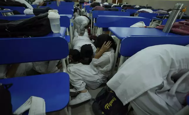 School students take shelter during mock drills amid India Pakistan tension, in Jammu, India, Tuesday, May 6, 2025. (AP Photo/Channi Anand)