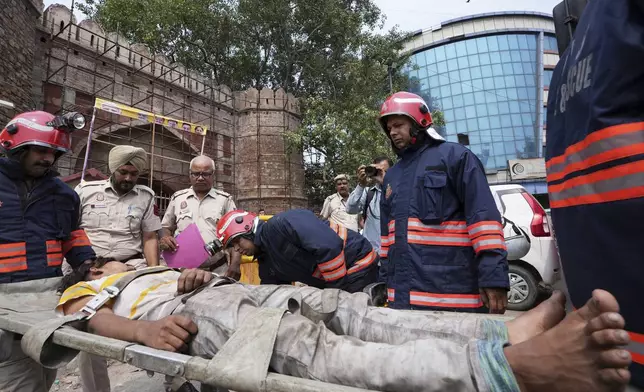 Firefighters carry out a mock drill to train civilians and security personnel to respond in case of an attack, old quarters of New Delhi, India, Saturday, May 10, 2025. (AP Photo/Karma Bhutia)