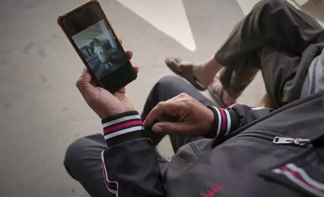 Samy Abed shows a picture of his 4-year-old daughter, Massa, before she was killed by an Israeli army strike in Zawaida, near the city of Deir al-Balah, Gaza Strip, Tuesday, April 29, 2025. (AP Photo/Abdel Kareem Hana)