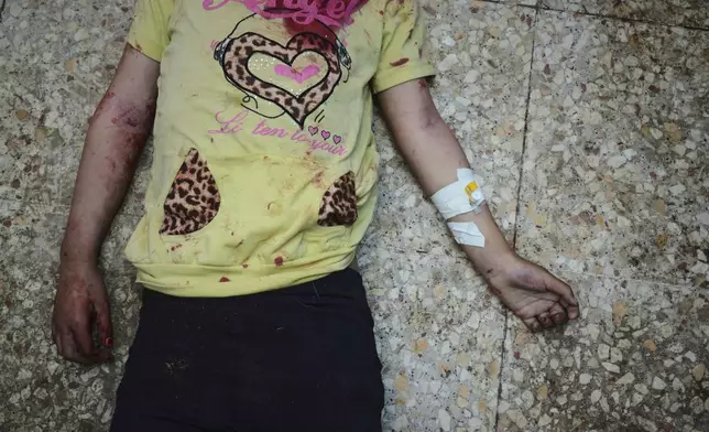 FILE - The body of Aya Al-Talli, 5, killed in an Israeli army airstrike of the Gaza Strip, lies on the floor of Al-Aqsa Hospital in Deir al-Balah, Sunday, April 27, 2025. (AP Photo/Abdel Kareem Hana, File)