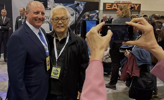 FILE - Berkshire Hathaway Vice Chairman Greg Abel poses for pictures with shareholders while touring the booths Berkshires companies set up, Friday, May 3, 2024, in Omaha, Neb. (AP Photo/Josh Funk, File)