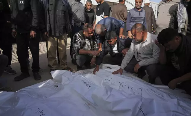 Palestinians mourn their relatives who were killed in an overnight Israeli airstrike, at Nasser Hospital in Khan Younis, Gaza Strip, Sunday, May 11, 2025. (AP Photo/Abdel Kareem Hana)
