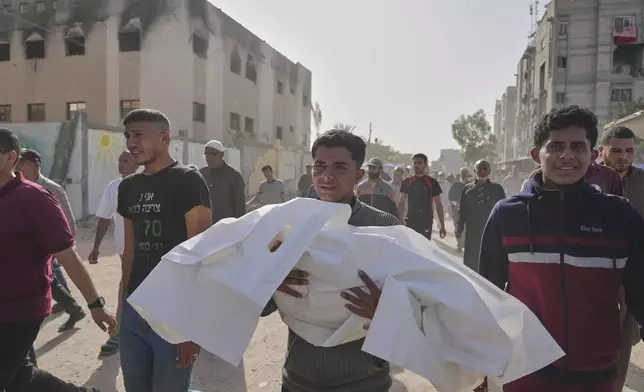 Palestinians carry the bodies of those who were killed in an overnight Israeli airstrike, during their funeral in Khan Younis, Gaza Strip, Sunday, May 11, 2025. (AP Photo/Abdel Kareem Hana)