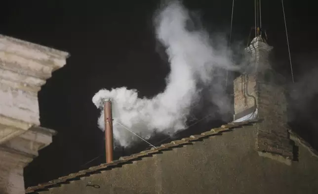 FILE - White smoke is seen billowing out from the chimney of the Sistine Chapel and announcing that a new pope has been elected on Wednesday, March 13, 2013. (AP Photo/Gregorio Borgia, File)