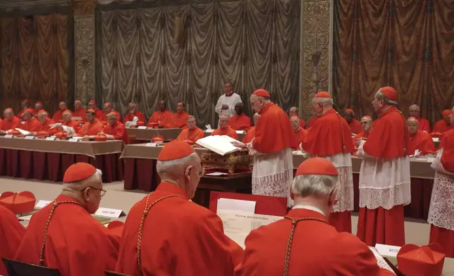 FILE - Italian Cardinal Giacomo Biffi, center, takes an oath at the beginning of the conclave to elect the next pope in the Sistine Chapel at the Vatican, Monday, April 18, 2005. (AP Photo/Osservatore Romano via AP, File)