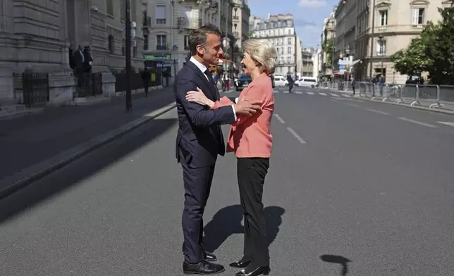 French President Emmanuel Macron welcomes European Commission President Ursula Von der Leyen as she arrives at the "Choose Europe for Science" event, to encourage researchers and scientists from all over the world to practice in Europe, at the Sorbonne University in Paris, Monday, May 5, 2025.(Gonzalo Fuentes/Pool via AP)