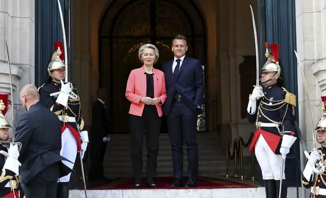 French President Emmanuel Macron welcomes European Commission President Ursula Von der Leyen as she arrives at the "Choose Europe for Science" event, to encourage researchers and scientists from all over the world to practice in Europe, at the Sorbonne University in Paris, Monday, May 5, 2025.(Gonzalo Fuentes/Pool via AP)