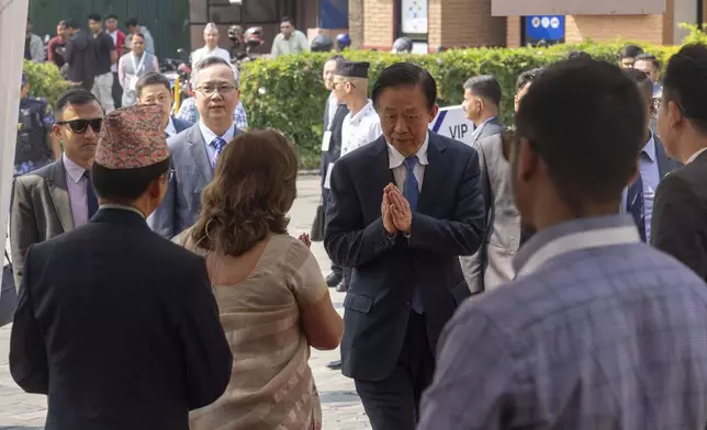 A Chinese delegate arrives to participate in an environment conference named Sagarmatha Sambaad (Mount Everest Dialogue) in Kathmandu, Nepal, Friday, May 16, 2025. (AP Photo/Niranjan Shrestha)