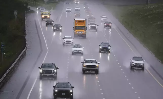 As rain from a nor'easter falls on the pavement, vehicles roll north on Route 93 during the start of the Memorial Day holiday travel, Thursday, May 22, 2025, in Londonderry, N.H. (AP Photo/Charles Krupa)
