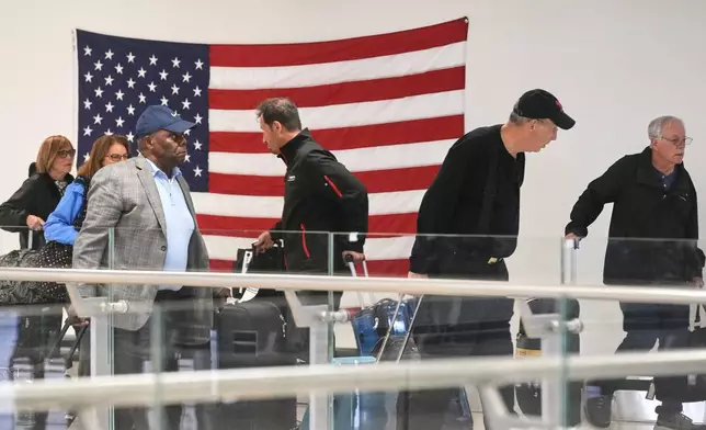 Passengers traverse Newark Liberty International Airport, in New Jersey, Friday, May 23, 2025. (AP Photo/Richard Drew)