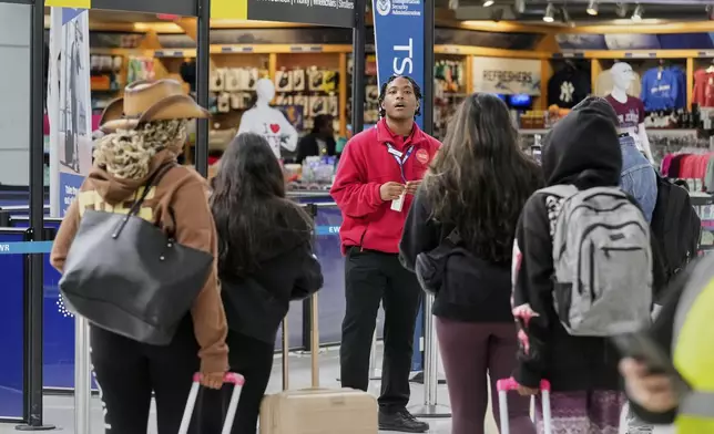 Passengers approach a TSA checkpoint at Newark Liberty International Airport, in New Jersey, Friday, May 23, 2025. (AP Photo/Richard Drew)