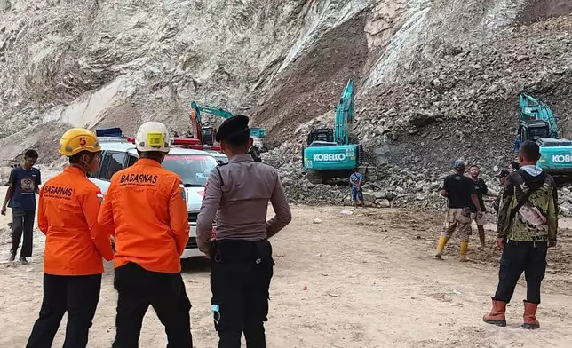 In this handout photo released by the Indonesian National Search and Rescue Agency (BASARNAS), rescuers search for victims at the site of a collapsed natural stones quarry in Cirebon district , West Java province, Indonesia, Friday, May 30, 2025. (BASARNAS via AP)