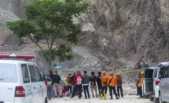 Indonesian rescue and a number of ambulances stand by as they continue to search for victims at the site of a collapsed natural stones quarry in Cirebon district, West Java province, Indonesia, Saturday, May 31, 2025.(AP Photo/Okri Riyana)