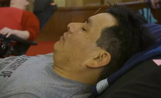 Juan Carlos Toapanta receives an acupuncture treatment in the sanctuary of St. Paul’s-San Pablo Lutheran Church, which recently added wellness sessions as part of its migrant ministry, in Minneapolis, Sunday, April 27, 2025. (AP Photo/Giovanna Dell’Orto)