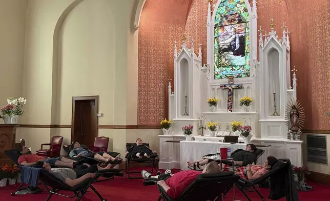 Congregants of St. Paul’s-San Pablo Lutheran Church receive acupuncture treatments in the sanctuary after worship during a wellness program the church started as part of its migrant ministry, in Minneapolis, Sunday, April 27, 2025. (AP Photo/Giovanna Dell’Orto)