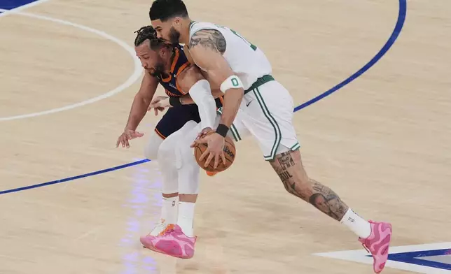 New York Knicks' Jalen Brunson, left, defends Boston Celtics' Jayson Tatum, right, during the first half of Game 4 in the Eastern Conference semifinals of the NBA basketball playoffs Monday, May 12, 2025, in New York. (AP Photo/Frank Franklin II)