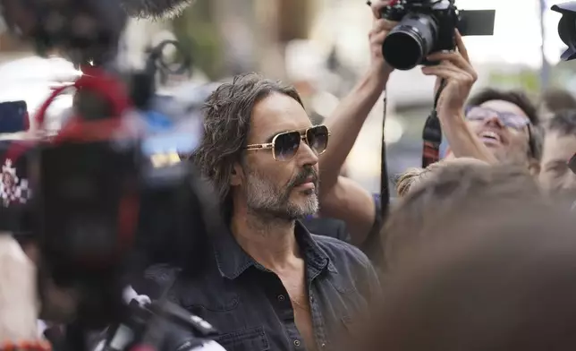 Actor--comedian Russell Brand arrives at Westminster Magistrates' court in London, Friday, May 2, 2025, to face charges of rape and sexual assault involving four women. (AP Photo/Alberto Pezzali)