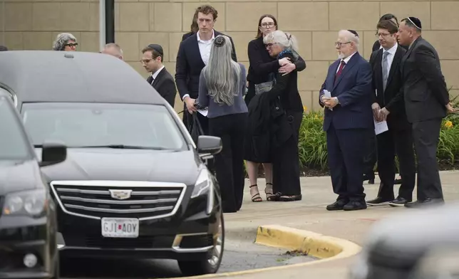 Family and friends gather outside Congregation Beth Torah after a funeral for Sarah Milgrim, a staffer at the Israeli Embassy who was killed last week outside a Washington Jewish museum, Tuesday, May 27, 2025, in Overland Park, Kan. (AP Photo/Charlie Riedel)