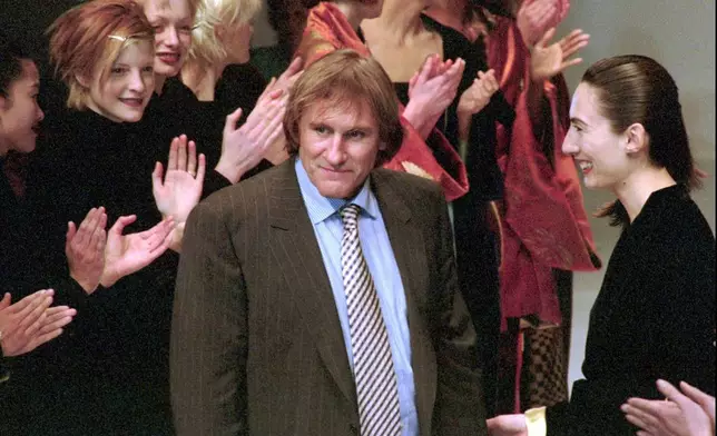 FILE - French actor Gerard Depardieu receives warm applause from the models at the unveiling of the Maska fashion show in Milan, Italy, Thursday, March 7, 1996. (AP Photo/Luca Bruno, File)