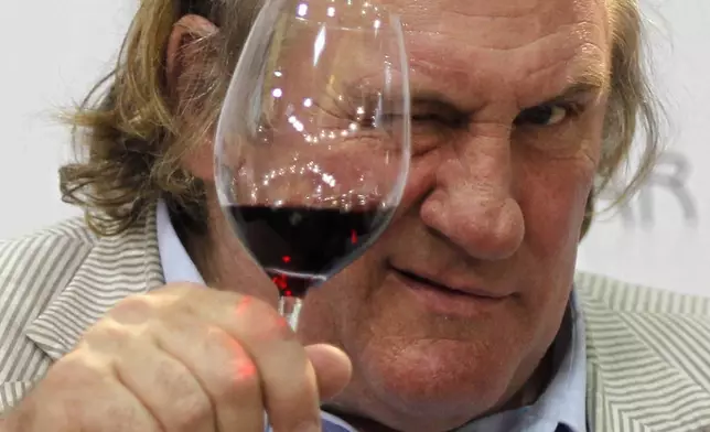 FILE - French actor Gerard Depardieu tests a glass of wine during a gastronomy fair in Duesseldorf, Germany, on Sept 12, 2010. (AP Photo/Roberto Pfeil/dapd, File)