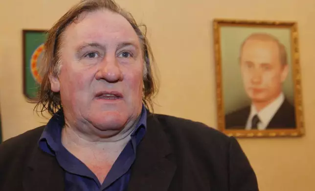 FILE - French actor Gerard Depardieu smiles shortly visits museum of Akhmad Kadyrov, war lord, who switched side and became pro-Russian leader, in Chechnya's provincial capital Grozny, Russia, on Feb. 24, 2013. (AP Photo/Musa Sadulayev, File)
