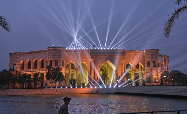 Lights are projected from former Iraqi leader Saddam Hussein's al-Faw Palace in Baghdad, Iraq, Saturday, May 24, 2025, now the location of The American University of Iraq - Baghdad. (AP Photo/Hadi Mizban)