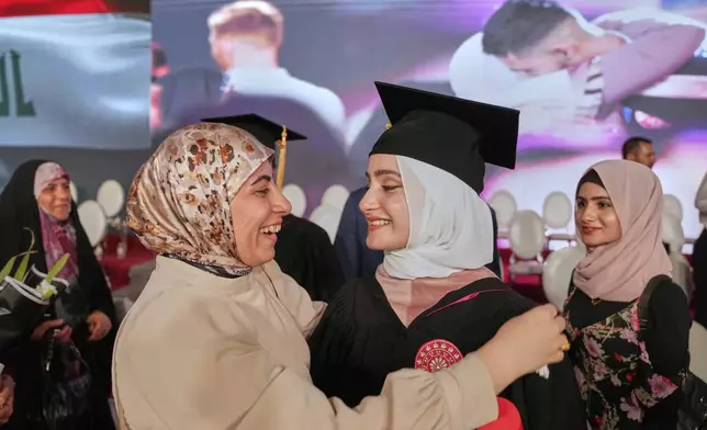 An Iraqi mother celebrates with her daughter during the first graduation for The American University of Iraq - Baghdad students in Baghdad, Iraq, Saturday, May 24, 2025. (AP Photo/Hadi Mizban)