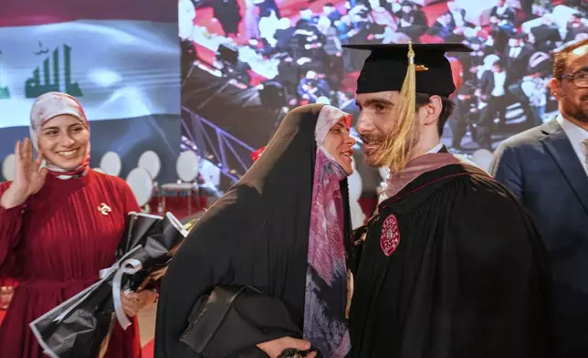 An Iraqi mother celebrates with her son during the first graduation for The American University of Iraq - Baghdad in Baghdad, Iraq, Saturday, May 24, 2025. (AP Photo/Hadi Mizban)