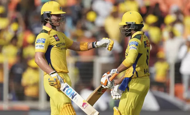 Chennai Super Kings' Dewald Brevis, left, celebrates with batting partner Ravindra Jadeja after scoring fifty runs during the Indian Premier League cricket match between Gujarat Titans and Chennai Super Kings at Narendra Modi Stadium in Ahmedabad, India, Sunday, May 25, 2025. (AP Photo/Ajit Solanki)
