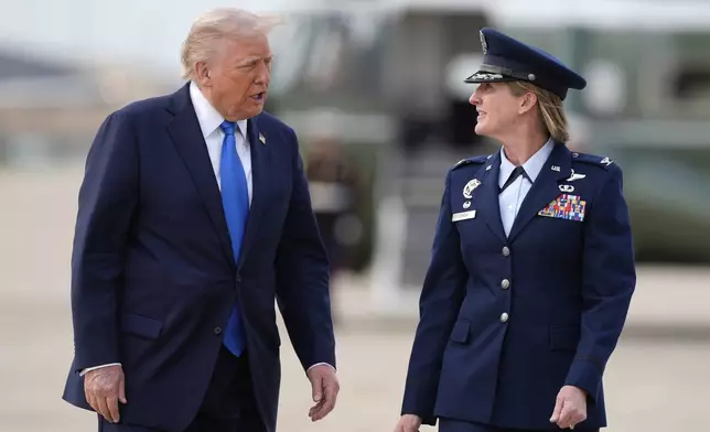 President Donald Trump walks with Air Force Col. Angela Ochoa, Commander of the 89th Airlift Wing from Marine One to board Air Force One at Joint Base Andrews, Md., en route Tuscaloosa National Airport, Thursday, May 1, 2025. (AP Photo/Manuel Balce Ceneta)