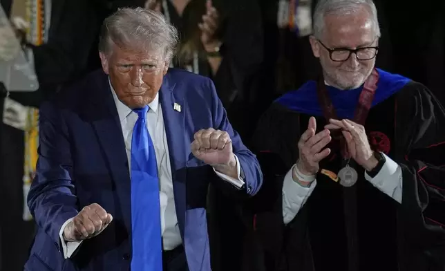 President Donald Trump dances after giving a commencement address at the University of Alabama, Thursday, May 1, 2025, in Tuscaloosa, Ala. (AP Photo/Mike Stewart)