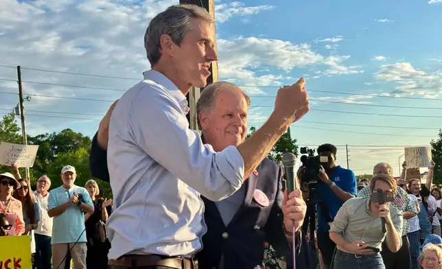 Former presidential candidate Beto O'Rourke of Texas speaks next to former U.S. Sen. Doug Jones of Alabama at a rally called "Tide Against Trump" in Tuscaloosa, Ala., held in opposition to President Donald Trump's appearance on campus on Thursday, May 1, 2025. (AP Photo/Kimberly Chandler)