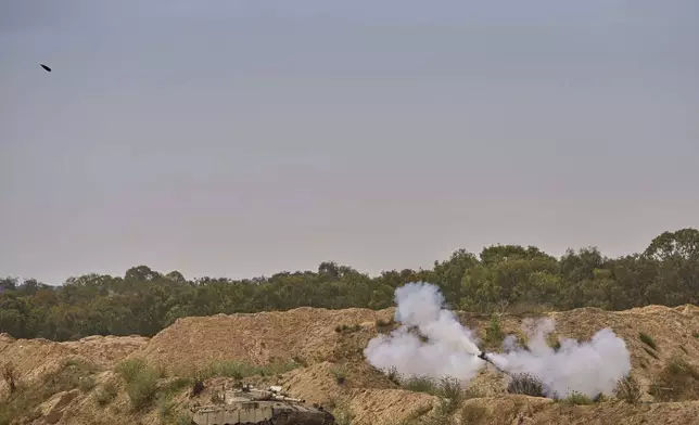An Israeli mobile artillery unit fires a shell from southern Israel towards the Gaza Strip, in a position near the Israel-Gaza border on Tuesday, May 6, 2025. (AP Photo/Ohad Zwigenberg)