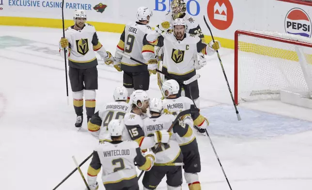 Vegas Golden Knights celebrate after winning Game 6 of a first-round NHL hockey playoff series against the Minnesota Wild, Thursday, May 1, 2025, in St. Paul, Minn. (AP Photo/Bailey Hillesheim)