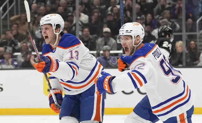Edmonton Oilers center Mattias Janmark, left, celebrates his goal with right wing Vasily Podkolzin during the third period in Game 5 of an NHL hockey first-round playoff series against the Los Angeles Kings, Tuesday, April 29, 2025, in Los Angeles. (AP Photo/Mark J. Terrill)